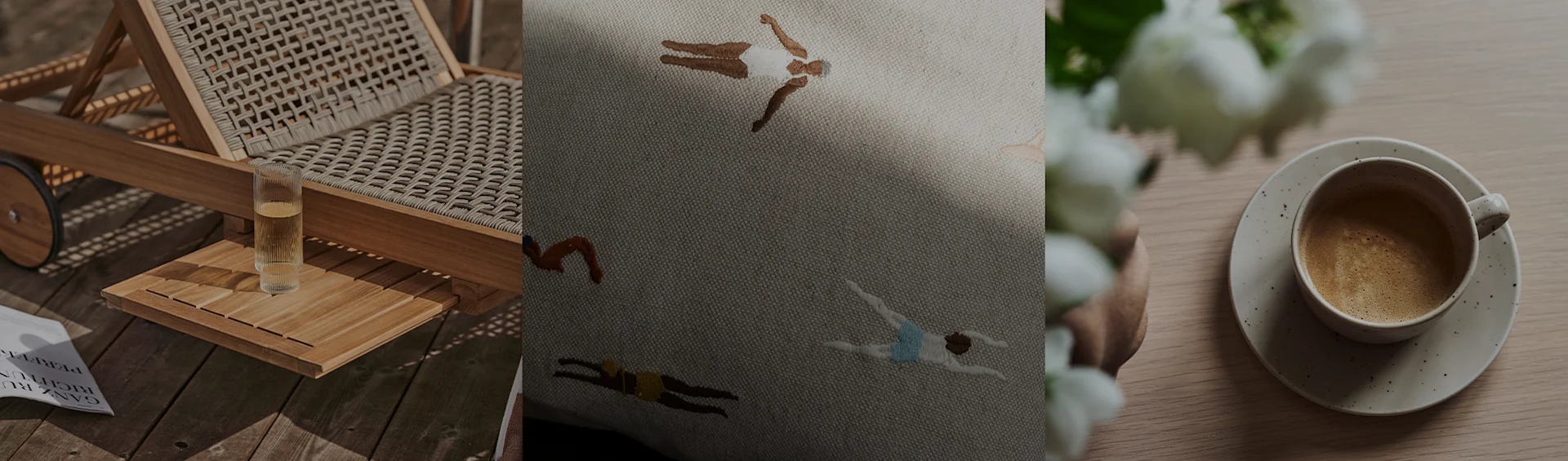 Una sedia a sdraio con una bevanda, un cuscino ricamato con nuotatori e una tazza di caffè con fiori bianchi.